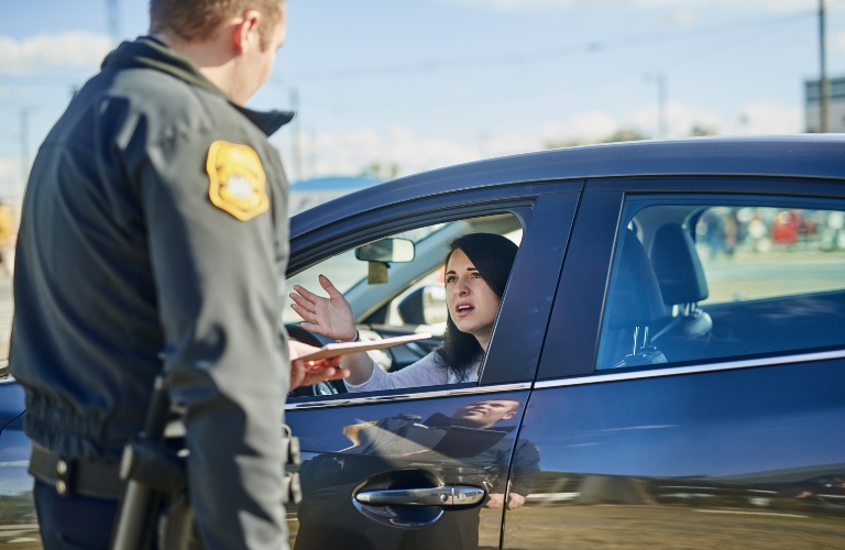 police officer stops a woman on the road