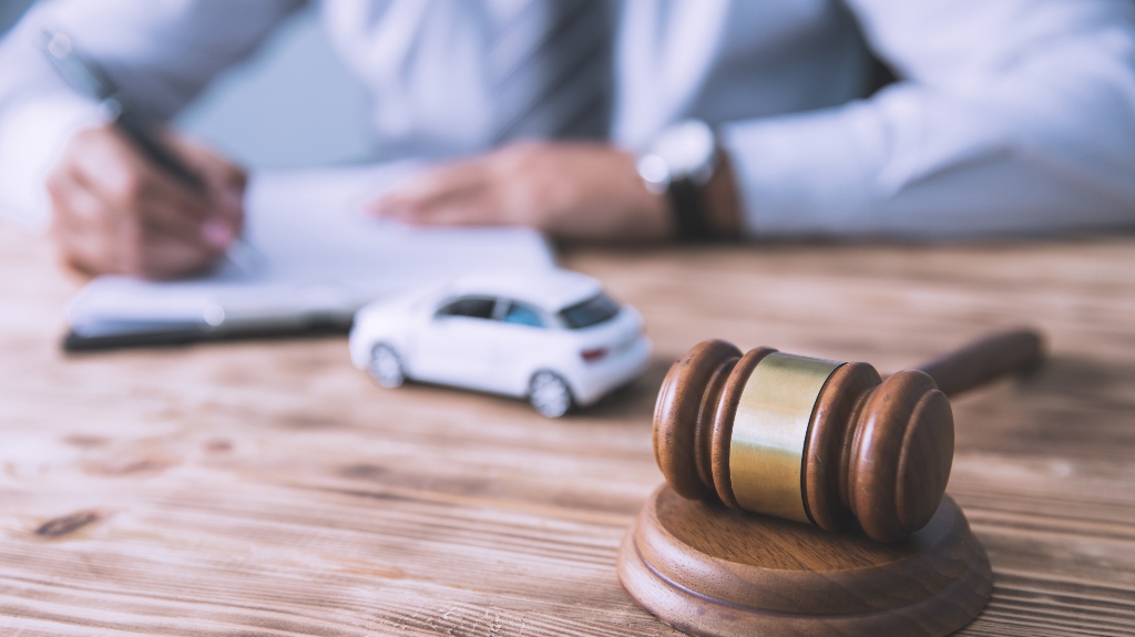 judge's gavel with car model and documents